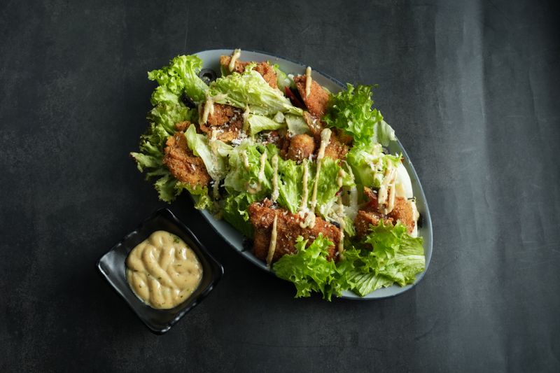 Punch Caesar Salad with romaine lettuce and parmesan crisps